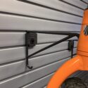 Horizontal Bike Hooks with prop on slatwall panel.